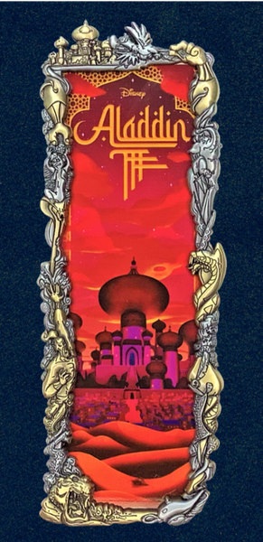 A pin badge featuring Aladdin Night theme with a two-tone frame, artist signature, and Disney branding.