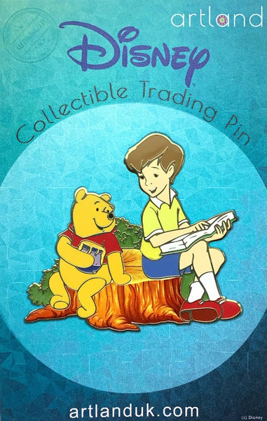 winnie the pooh is sat with christopher robin on a tree stump. christopher is pointing at a page in a book and winnie is holding a pot of honey. they are smiling at eachother.